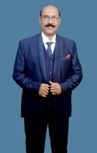 Man in formal suit against blue background.