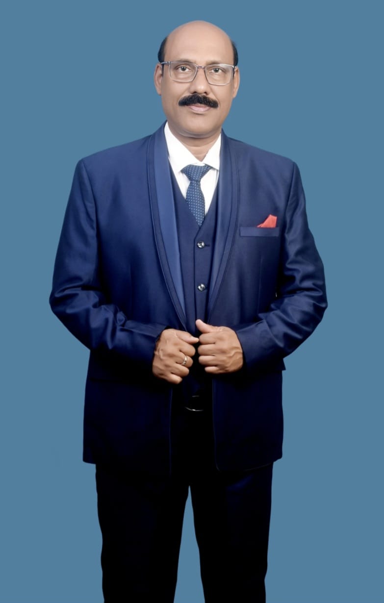 Man in formal suit against blue background.